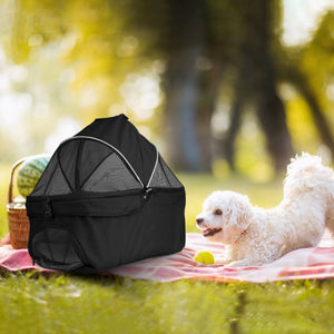 small white dog stretching on a picnic blanket next to a black detachable pet stroller carrier with mesh canopy – AGG Gear
