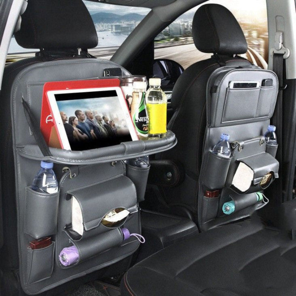 Grey seat-back organizer with folding tray, cup holders and tissue pocket behind front seat