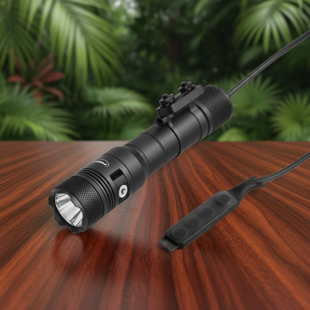 Powertac Huntsman Picatinny flashlight with rail mount and remote pressure switch on wood table with forest backdrop