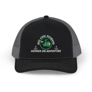 Reel Cool Husband embroidered trucker cap, front view, black front with charcoal mesh back